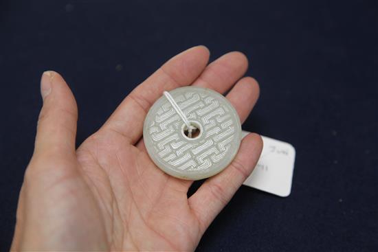 A Chinese pale celadon bi disc, 19th century, diameter 5.1cm